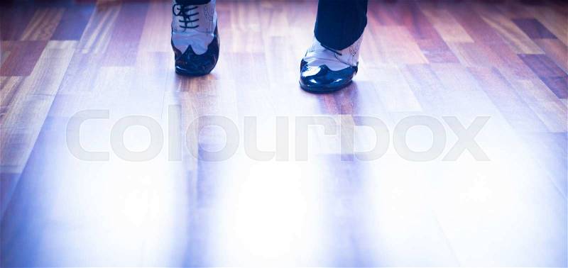 Male ballroom, standard, sport dance, latin and salsa dancer feet and shoes in dance academy school rehearsal room dancing jazz fusion, stock photo