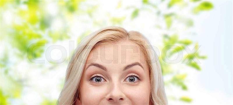 Curiosity, advertisement and people concept - happy young woman or teenage girl face over green natural background, stock photo