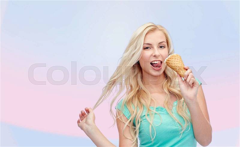 Summer, junk food and people concept - young woman in sunglasses eating ice cream over pink background, stock photo