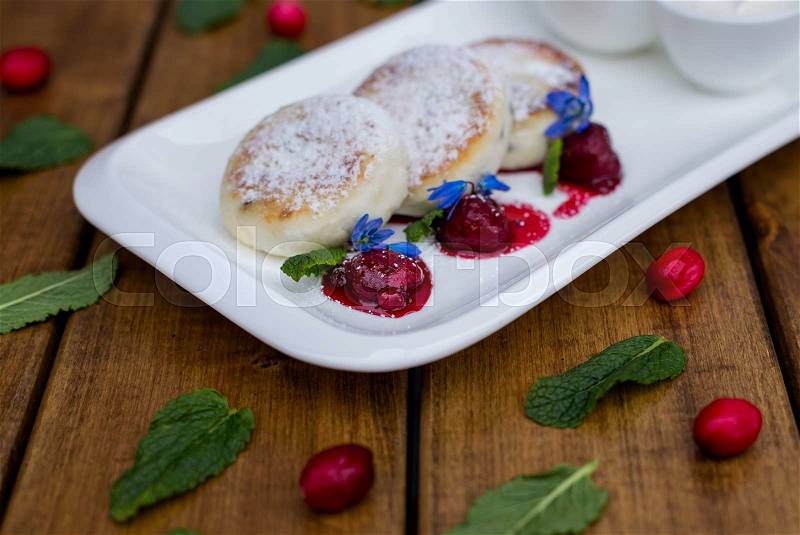 Cottage cheese pancakes with mint and powdered sugar, flowers, breakfast, stock photo