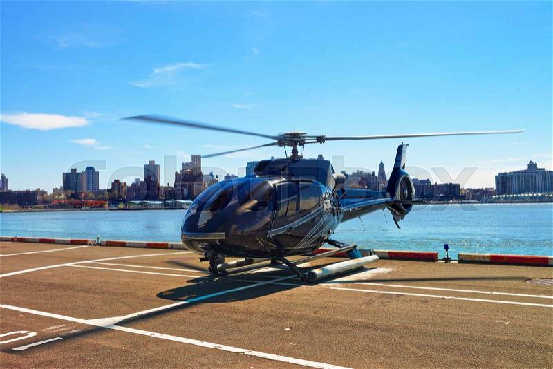 Black Helicopter on the helipad in Lower Manhattan in New York, USA, on East River. Pier 6, stock photo