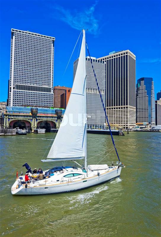 Sailing boat and Lower Manhattan of New York, USA, on the background. East River. Tourists on board, stock photo