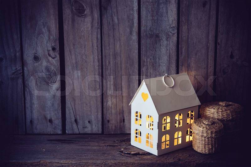 Cozy vintage home decoration: warm interior night light on an old wooden board background, stock photo