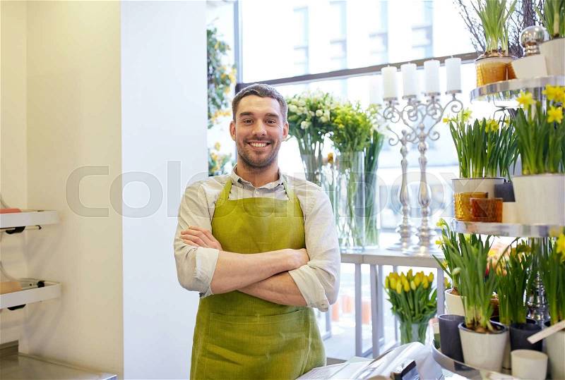 People, sale, retail, business and floristry concept - happy smiling florist man or seller standing at flower shop counter, stock photo