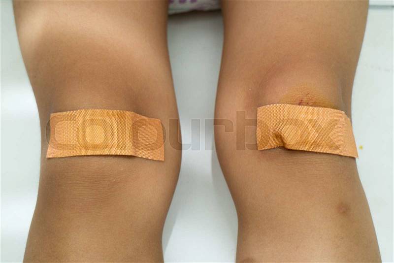 Child with Band Aid on Knee in Isolated White Background, stock photo