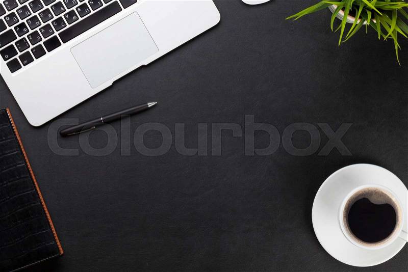 Office leather desk workplace table with laptop, coffee cup, notepad and plant. Top view with copy space, stock photo