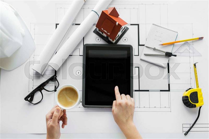 Business, architecture, building, construction and people concept - close up of architect hand with living house blueprint and tablet pc computer, stock photo
