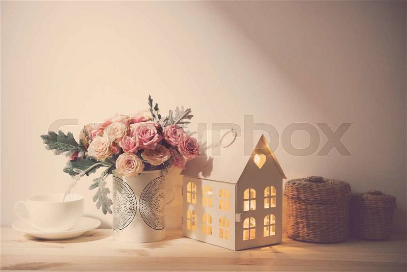 Beautiful vintage home decorations: flowers and decorative objects on the shelf by the wall. House decor background, stock photo
