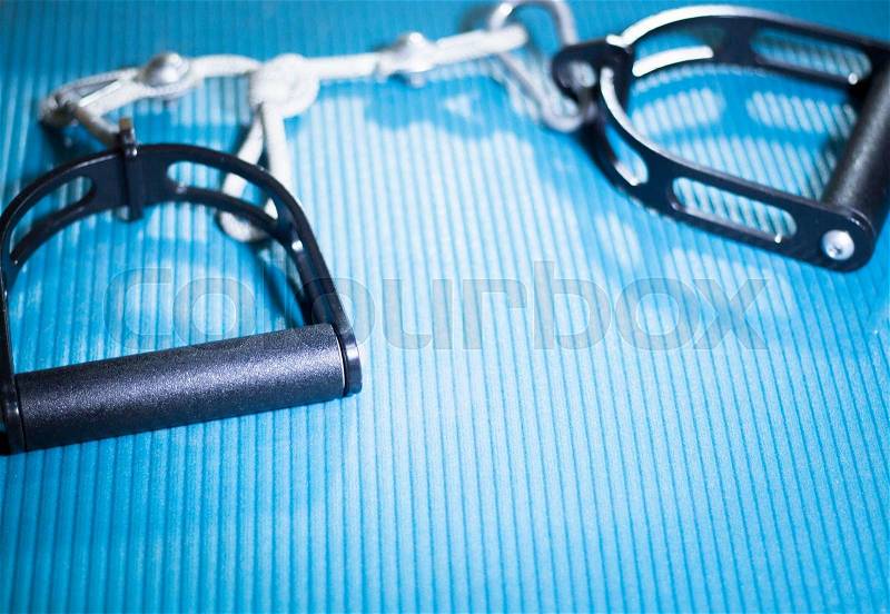 Yoga pilates fitness band strap in gym on exercise mat for sports and strength training, stock photo