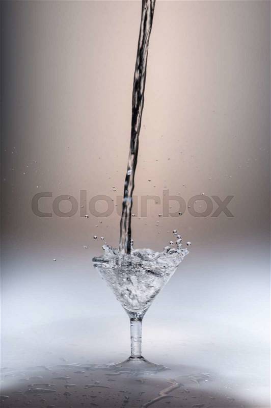 Cold splashing water drink with ice cube, stock photo