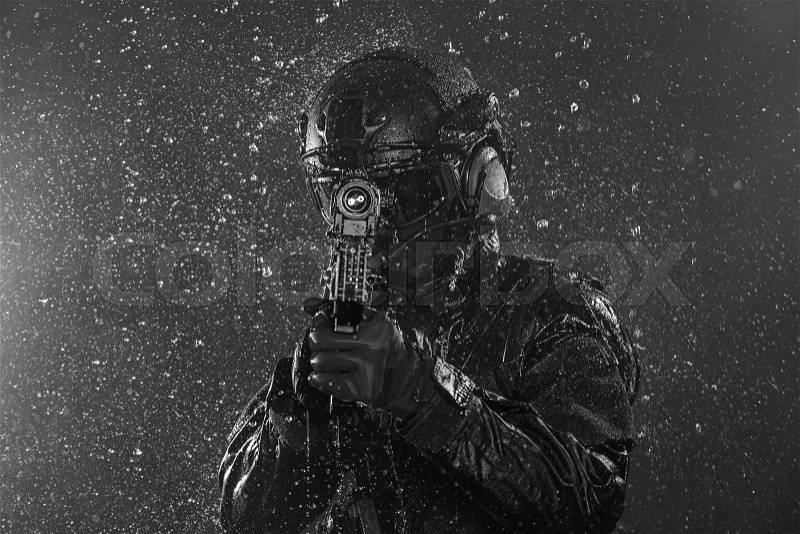 Spec ops police officer SWAT in the rain, stock photo