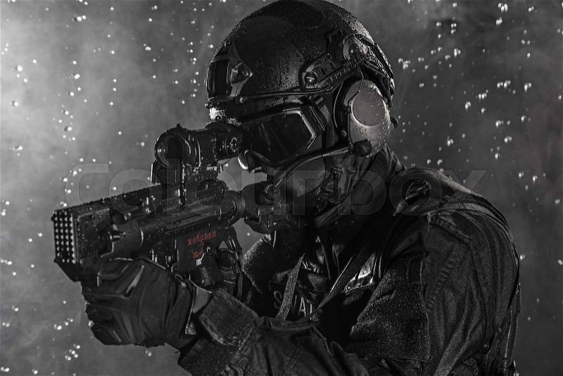 Spec ops police officer SWAT in the rain, stock photo