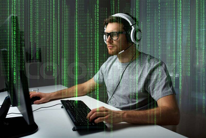 Technology, gaming, entertainment, let\'s play and people concept - young man in headset and glasses with pc computer playing game at home and streaming playthrough or walkthrough video, stock photo
