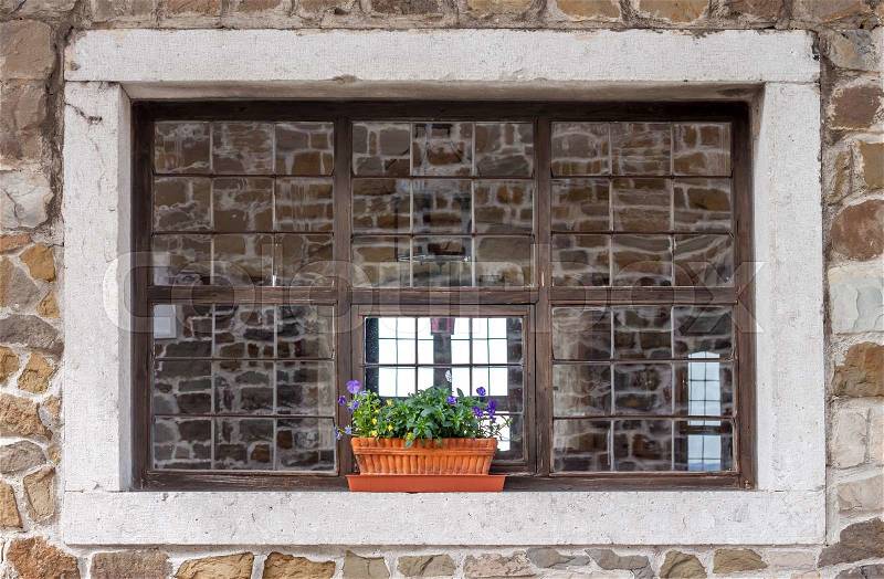 Old castle window with pot flowers as background, stock photo