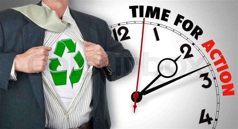 Businessman showing superhero suit with recycling symbol underneath his shirt standing against clock with time for action - path for the shirt, stock photo