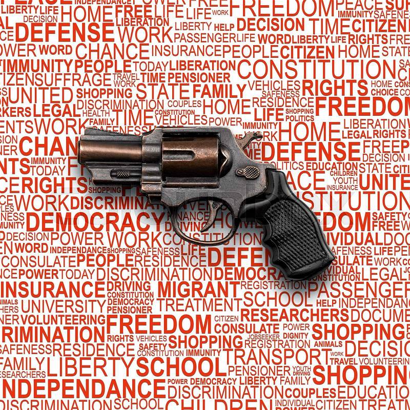 Revolver Gun, toy for children with background concept wordcloud of human rights , stock photo