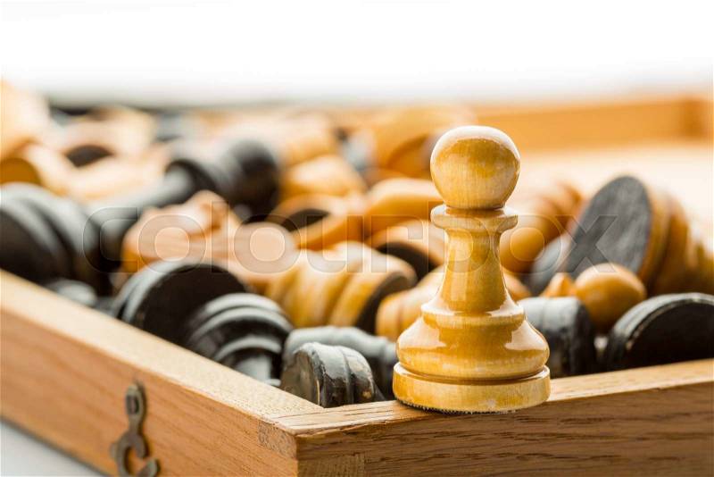 A wooden pawn on the chess box close up, stock photo