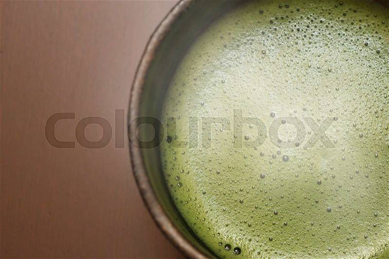 Close-up of hot cup of japanese matcha green tea with smoke, stock photo