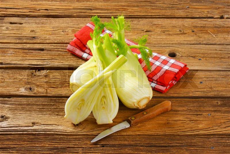 Bulbs of fresh fennel on wooden table, stock photo