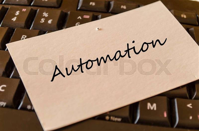 Automation - note on keyboard in the office, stock photo