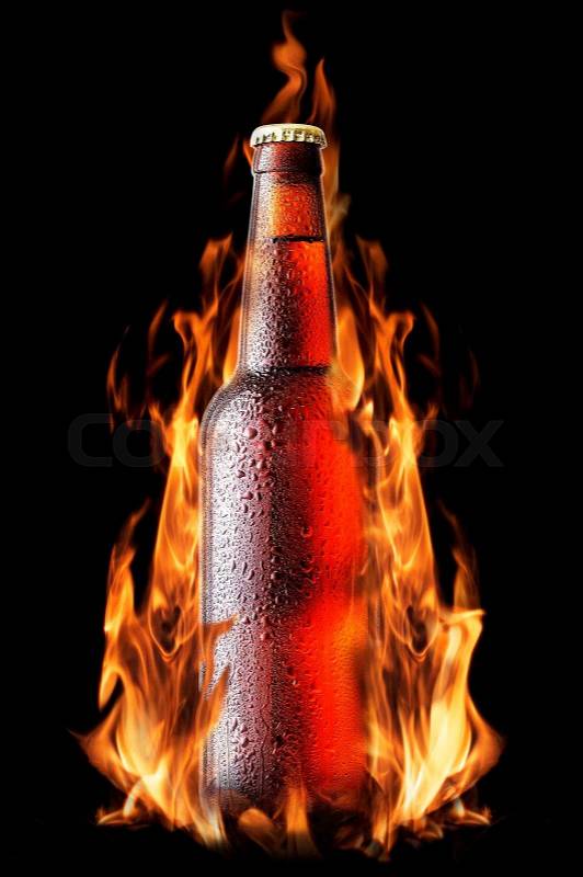 Brown beer bottle with drops in the fire, stock photo