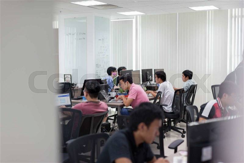 Asian Software Developers Office Team Sitting At Desk Working Laptop Computer Business People Group Real Office, stock photo