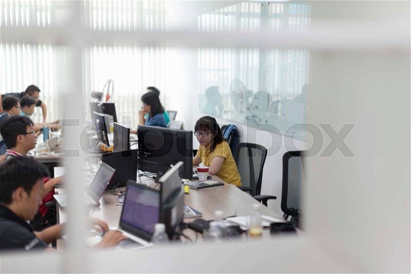 Asian Software Developers Office Team Sitting At Desk Working Laptop Computer Business People Group Real Office, stock photo