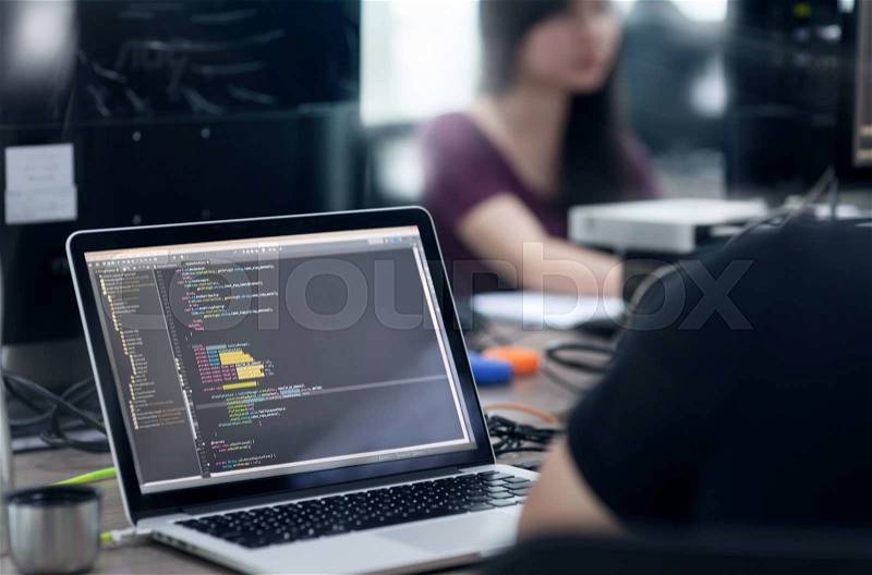 Asian Outsource Developer Team Sitting At Desk Working Laptop Computer Mobile Application Software Real Office, stock photo