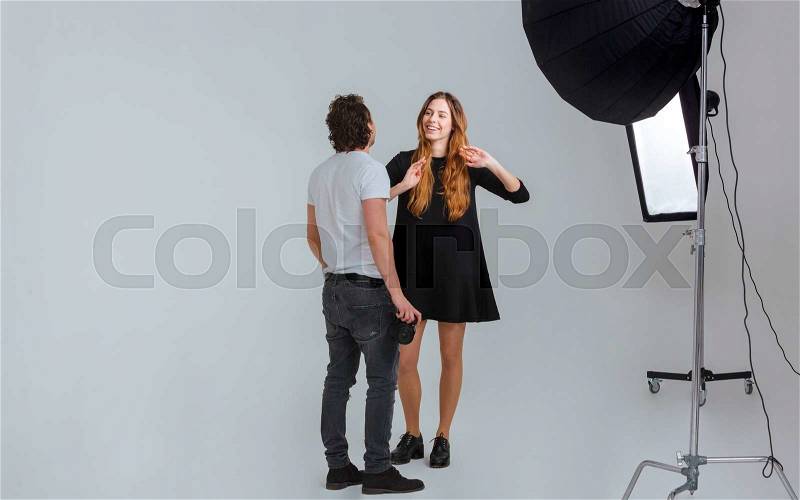 Photographer working with model in studio with equipments, stock photo