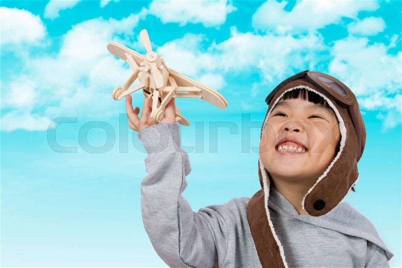 Asian Little Chinese Girl Playing with Toy Airplane against Blue Sky Background, stock photo