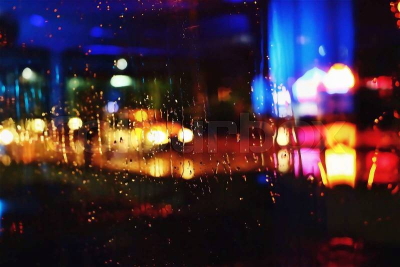 Photos night city made through glass. Street. Rain. Bokeh Lights Out Of Focus, stock photo