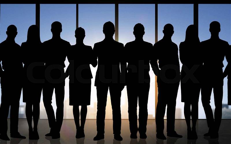 Business, teamwork and people concept - business people silhouettes over office background, stock photo