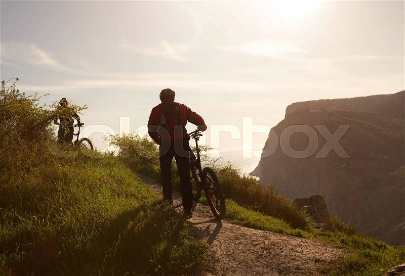 Group of people traveling through the countryside on mountain bikes, stock photo