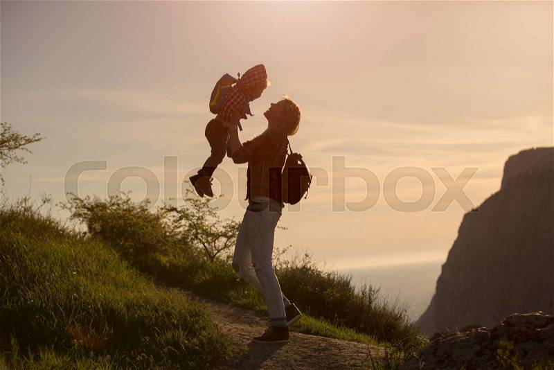 Beautiful family of mother and son walking near the sea, stock photo
