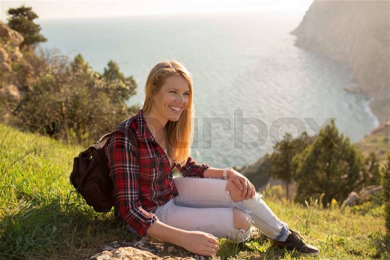 Young Woman resting near the sea at sunset. on background Travel Lifestyle and happiness concept, stock photo
