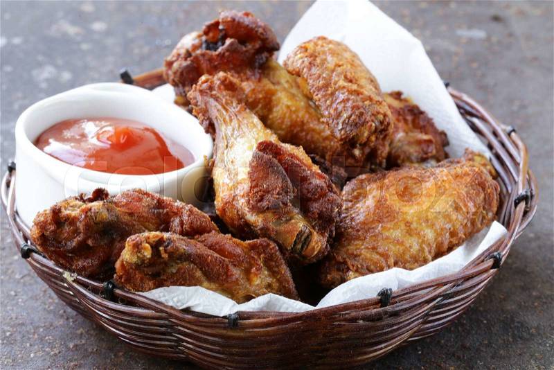 Fried chicken wings with sauce and spices, stock photo