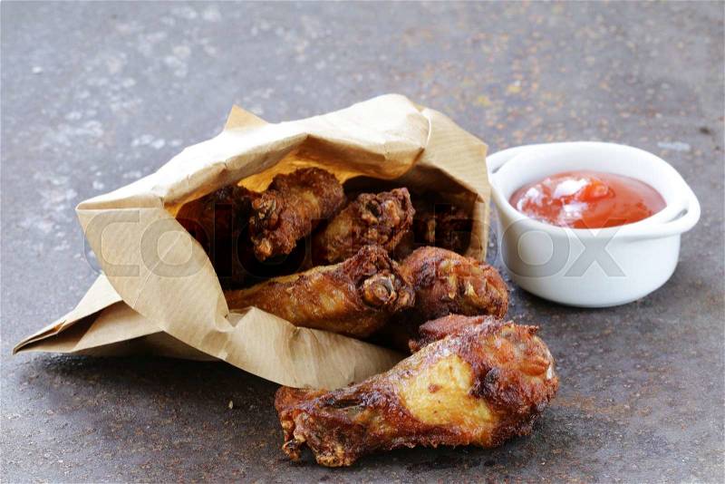 Fried chicken wings with sauce and spices, stock photo