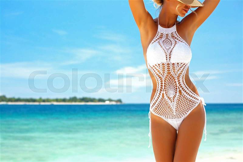 Beautiful woman wearing crochet bikini posing over the sea view, beach lifestyle, stock photo