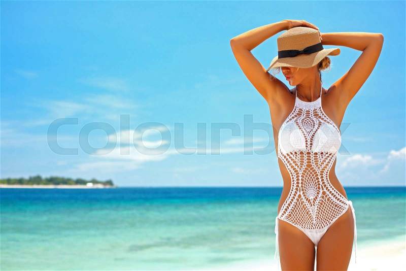 Beautiful woman wearing crochet bikini posing over the sea view, beach lifestyle, stock photo