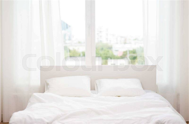 Rest, interior, comfort and bedding concept - bed at home bedroom, stock photo