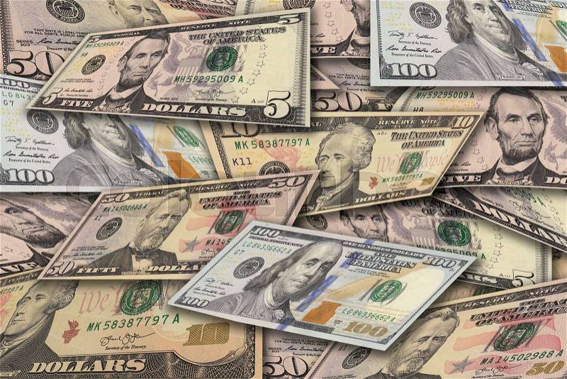 Pile of dollar banknotes in different currency 5 dollar, 10 dollar, 50 dollar and 100 dollar currency of the United States useful as a background, stock photo