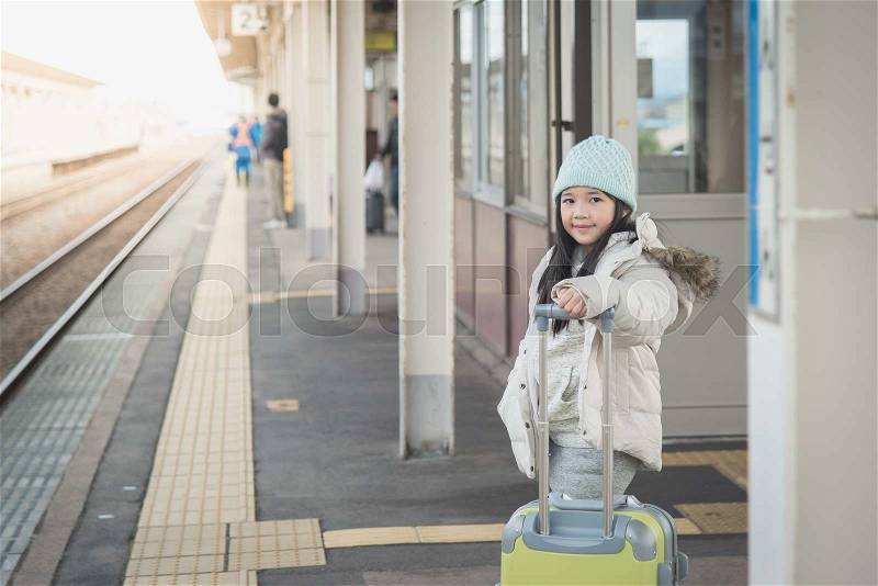 Beautiful Asian girl waiting for train and happy about a journey, stock photo