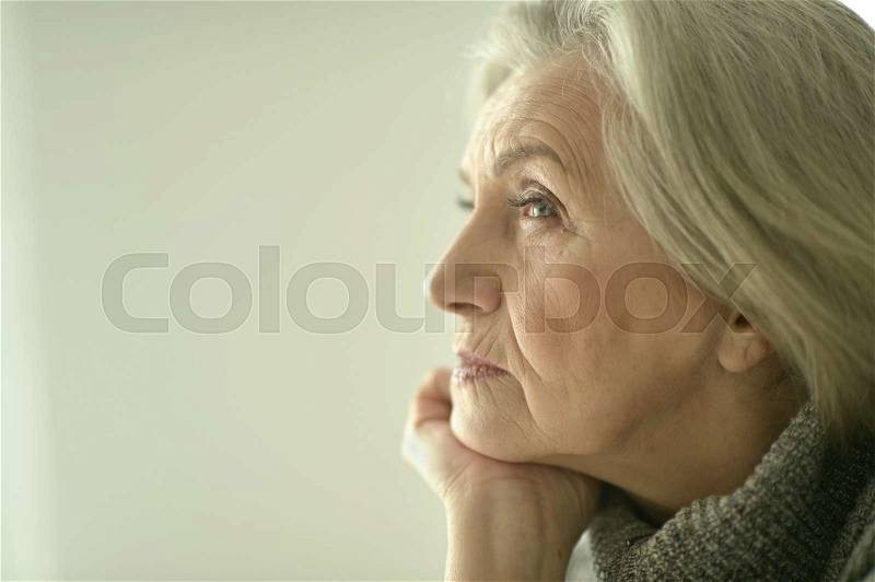 Portrait of a thoughtful sad elderly woman, stock photo