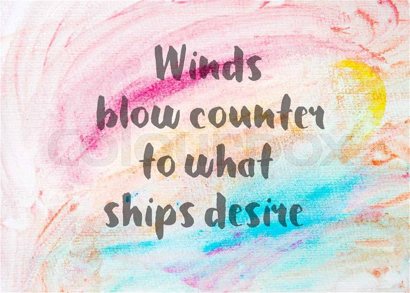 Winds blow counter to what ships desire. Inspirational quote over abstract water color textured background, stock photo