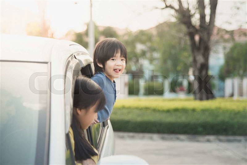 Happy asian children sitting in the car, stock photo