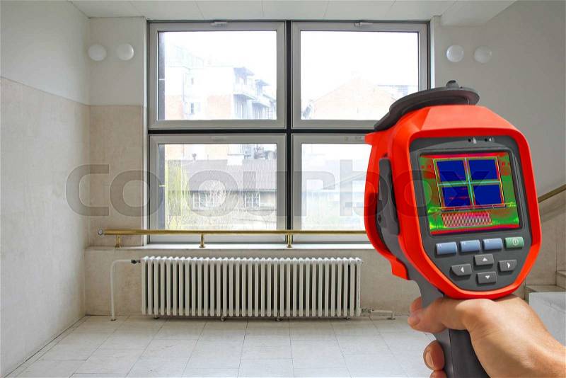 Recording Radiator Heater and a window on a building using Infrared Thermal Camera, stock photo