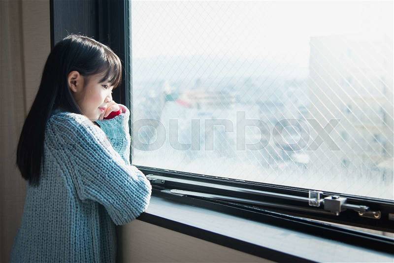 Beautiful asian girl looking at the window, stock photo