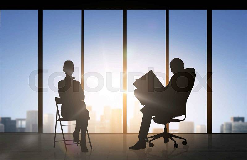 Business, teamwork and people concept - silhouette of people working over office window background, stock photo