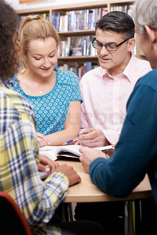 Group Of Mature Students Studying In Library, stock photo