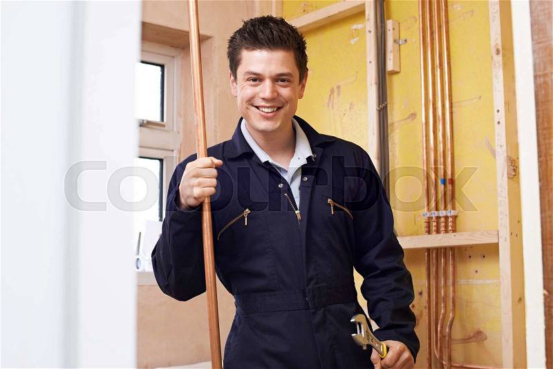 Portrait Of Plumber Working In House, stock photo
